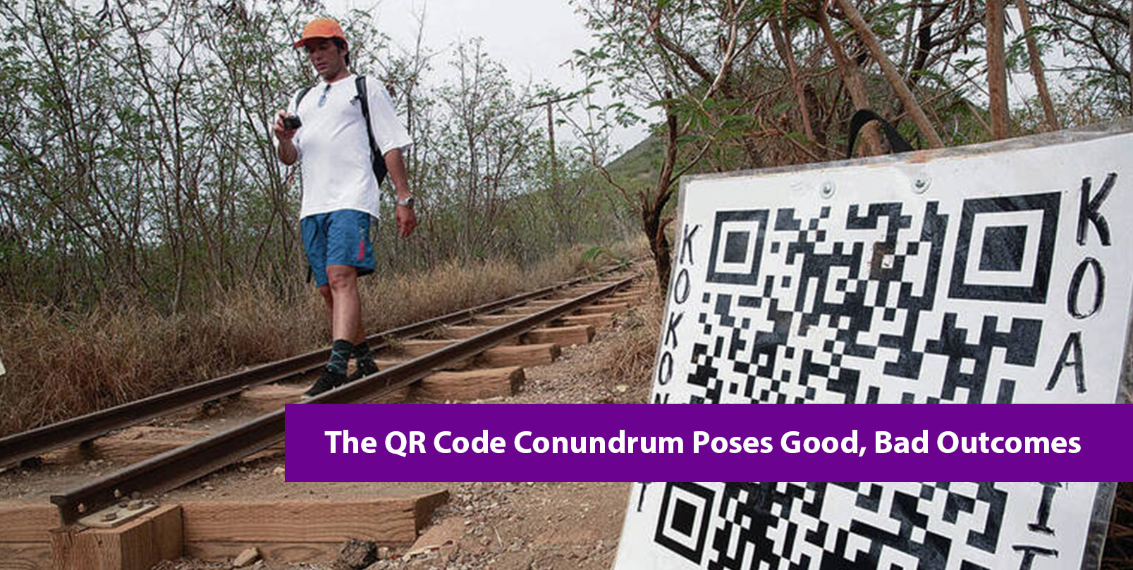 Man walking down koko head steps holding a camera and a QR code is shown on the right side of the screen.